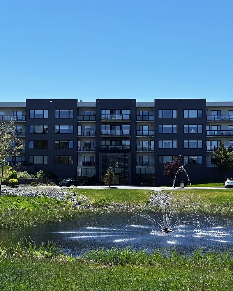 Shiraz Gardens Amarone apartment building in Hammonds Plains, Nova Scotia with pond and nature surrounding it