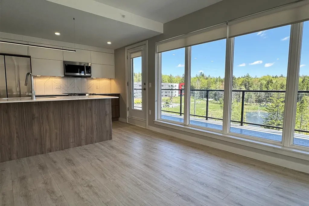 Shiraz Gardens apartment kitchen showing balcony with views of trees and pond
